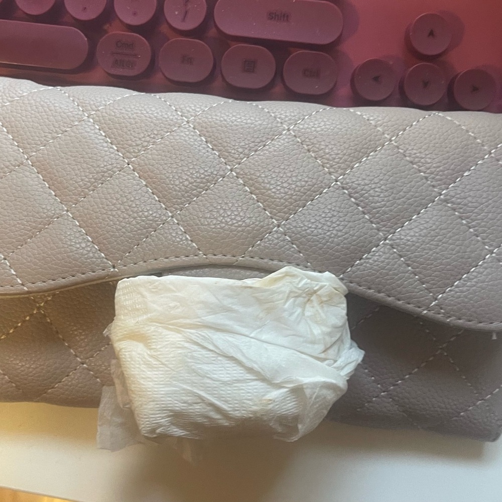 Quilted beige clutch can be worn with a chain strap or without